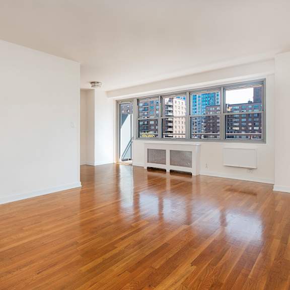 empty room with wooden floor and white walls.