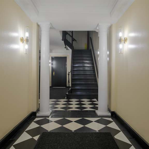 a hallway with a black and white checkered floor.