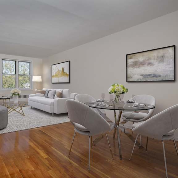 a modern living room with a glass table and grey chairs.