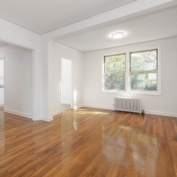 a room with wooden floors and white walls.