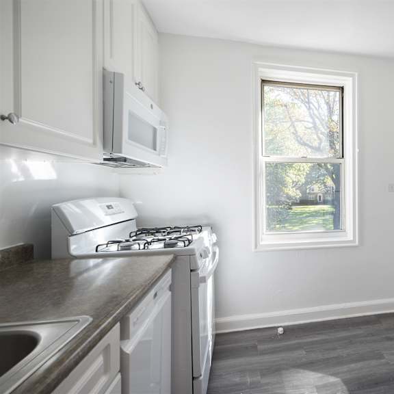 a kitchen with a stove, microwave, and dishwasher.