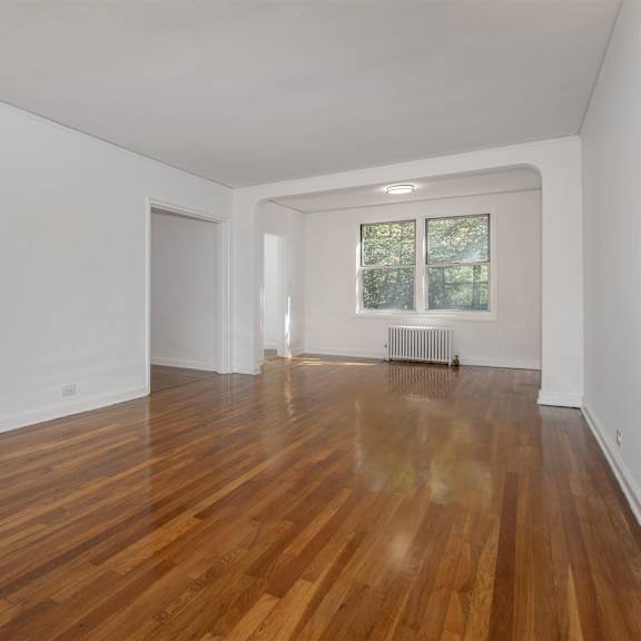 a room with wooden floors and white walls.