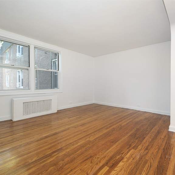 a room with wooden floors and a white door.
