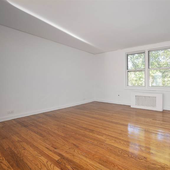 a room with a window and a radiator on the wall.