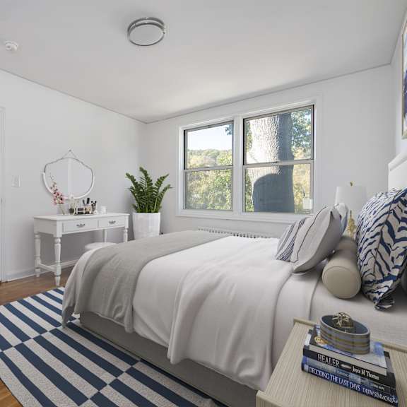 a bedroom with a bed, nightstand, and a window.