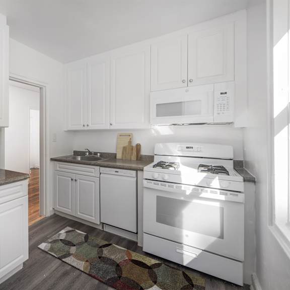a kitchen with white appliances and cabinets.