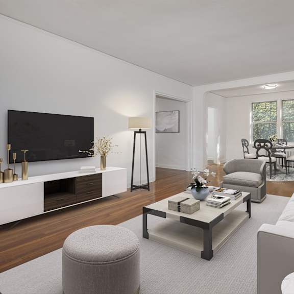 a modern living room with a grey sofa, a white coffee table, and a television.