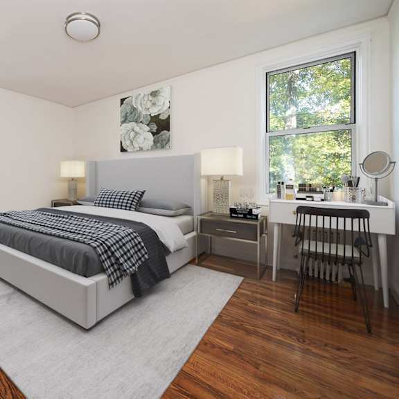 a bedroom with a bed, desk, chair, and potted plant.
