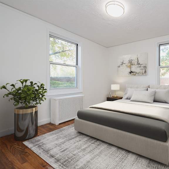 a bedroom with a large bed and a plant in a planter.