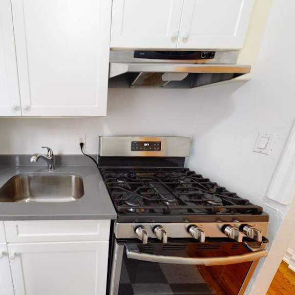 a modern kitchen with a stove and sink.