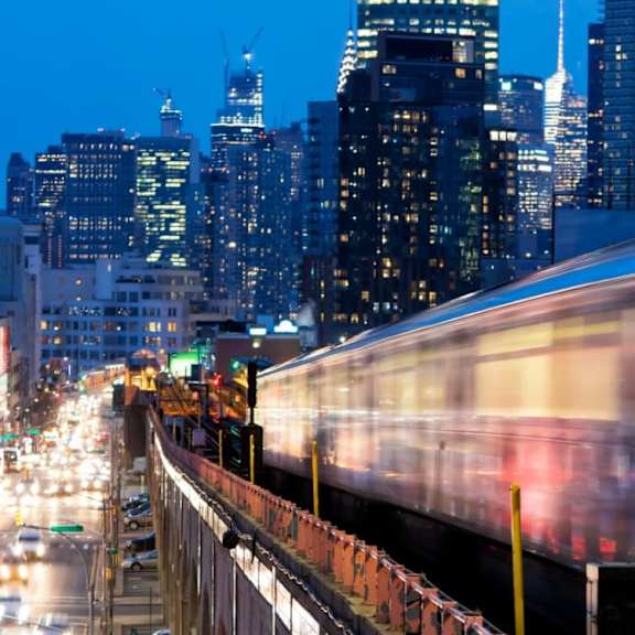 a train is passing through a city at night.