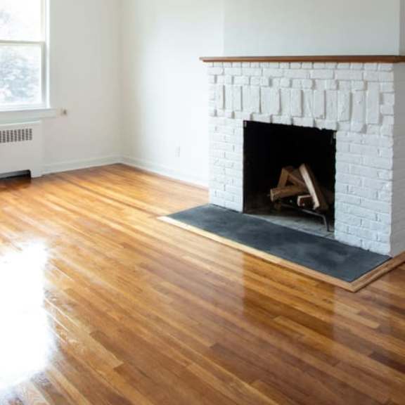 a white fireplace with a fire in it.