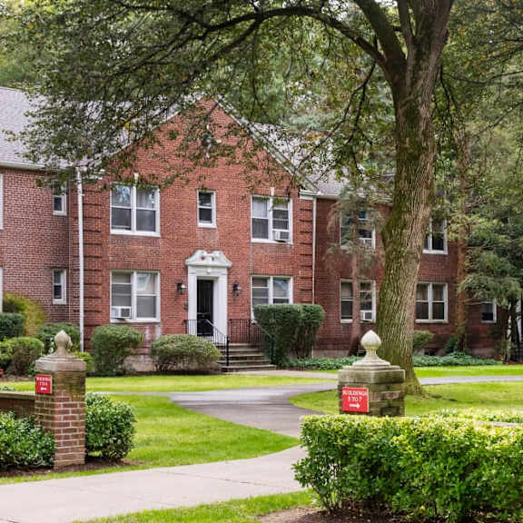a red brick building with a black door and windows.