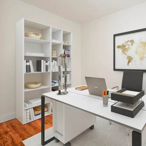 a laptop is on a desk with a world map on the wall.