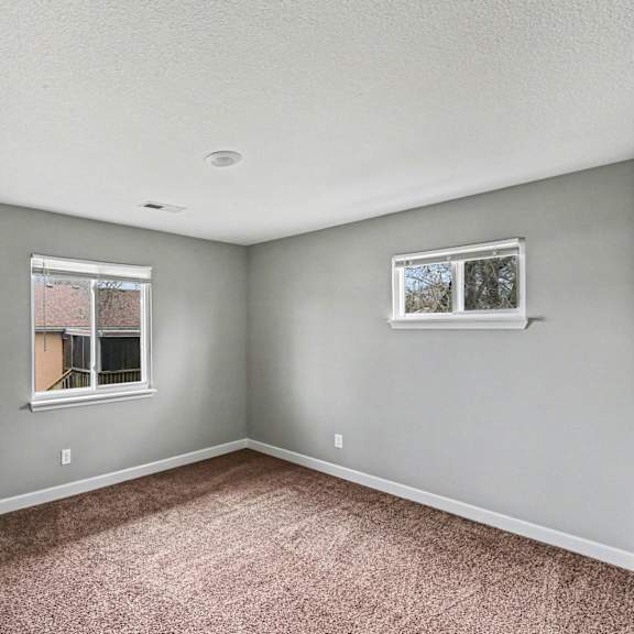 a room with a carpeted floor and a window.