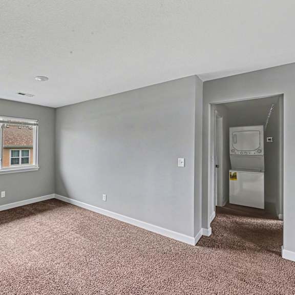 a room with a window and a door leading to another room.