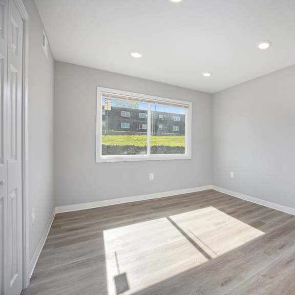 a room with a large window and a wooden floor.at palisades apartments, kansas city missouri