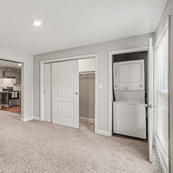 a white kitchen with a fridge, oven, and microwave.