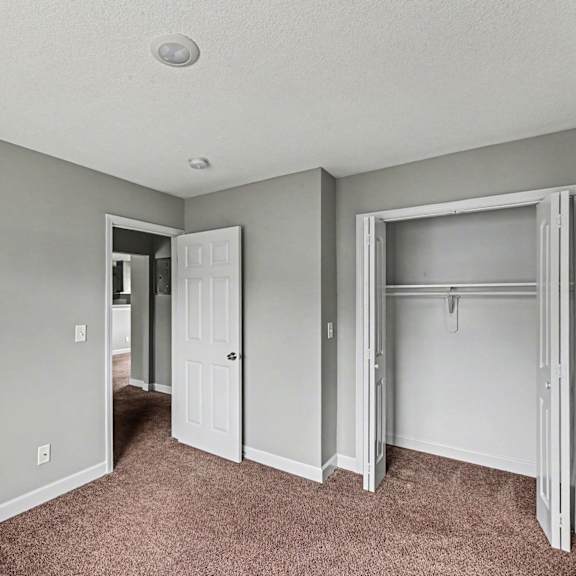 a room with a carpeted floor and a white door.