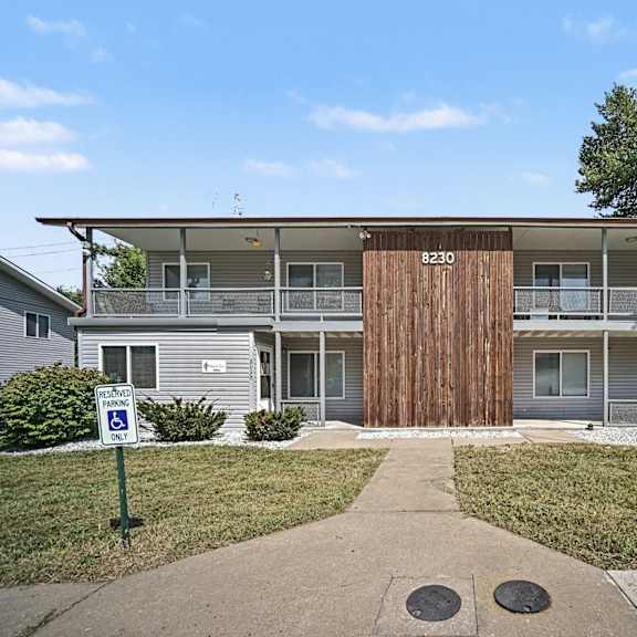 a building with a brown door and a sign that says 230.