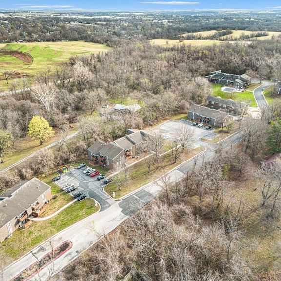 a bird's eye view of a residential area with houses and a parking lot.