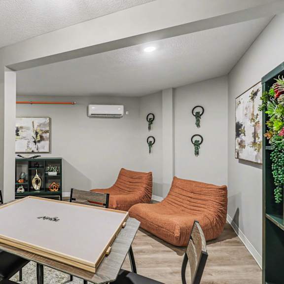 a room with a pool table and a couch. at mayfair apartments, kansas city