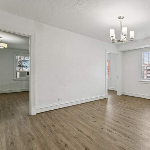 a room with wooden floors and white walls at shipyard shores apartments, virginia