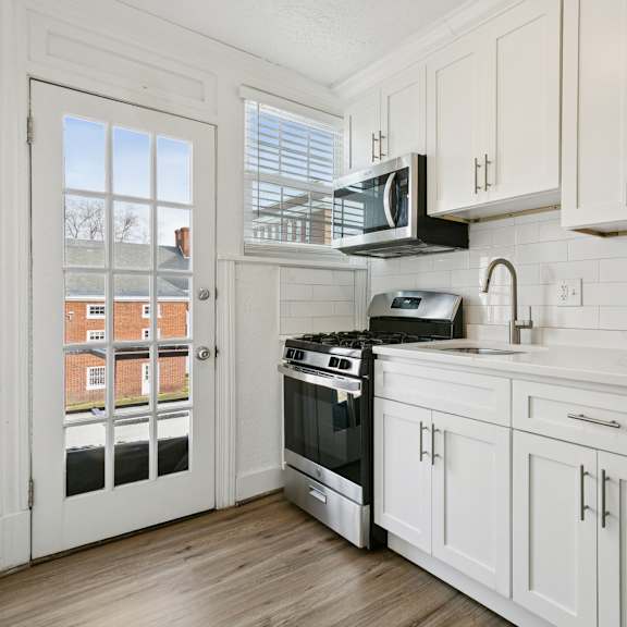 a kitchen with white cabinets and a stainless steel refrigerator at shipyard shores apartments, virginia, 23607