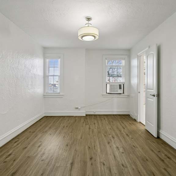 a room with wooden floors and white walls at shipyard shores apartments, apartments, newport news, va