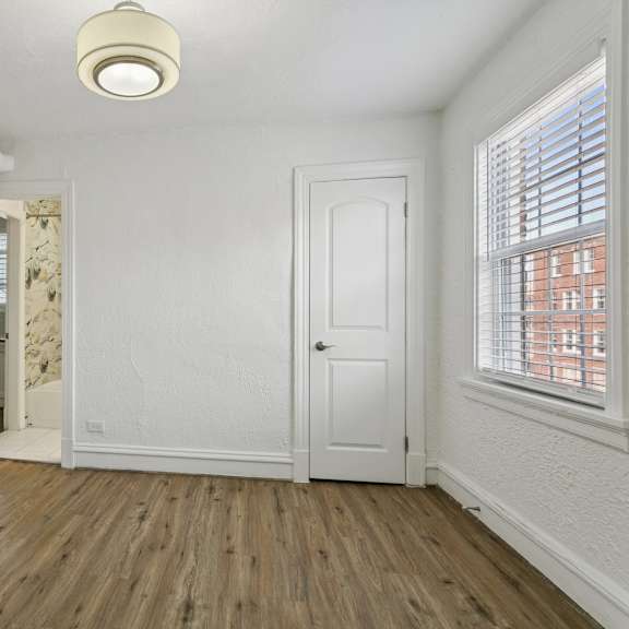 a room with a wooden floor and white walls at shipyard shores apartments, virginia, 23607