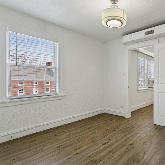 a room with a white door and a window with blinds at shipyard shores apartments, newport news, va, 23607