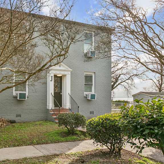 a grey house with a front yard and a bare tree at shipyard shores apartments, newport news, virginia