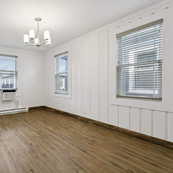 a room with wooden floors and white walls at shipyard shores apartments, newport news