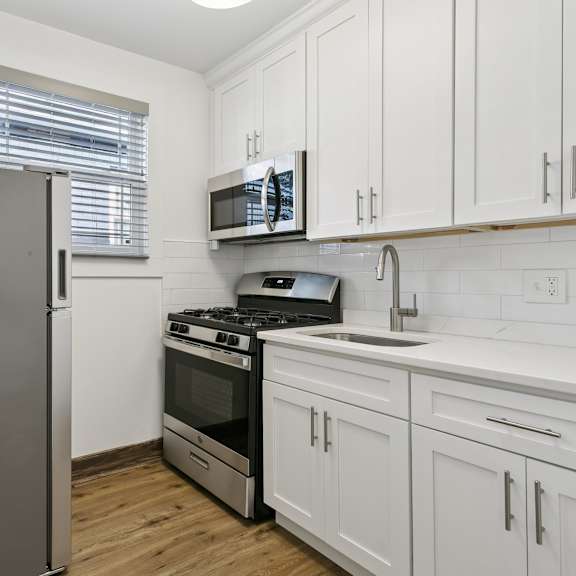 a kitchen with a refrigerator, stove, oven, and microwave at shipyard shores apartments, apartments, newport news, va