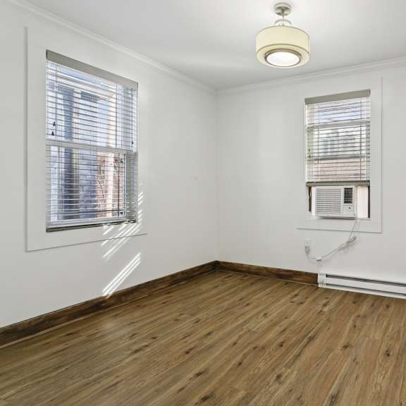 a room with a window and a radiator on the floor at shipyard shores apartments, newport news, virginia