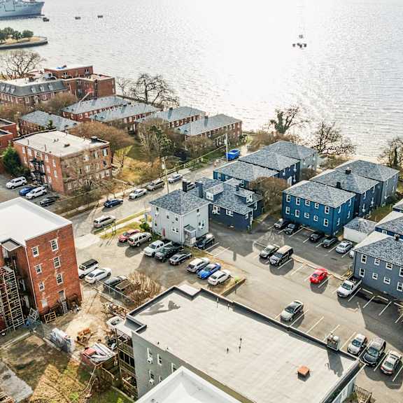 a view of a waterfront area with a parking lot and buildings at shipyard shores apartments, apartments, newport news, va