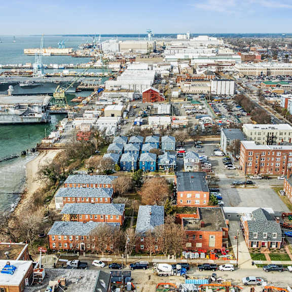 a cityscape with a large body of water and a dock with boats at shipyard shores apartments, newport news, va, 23607