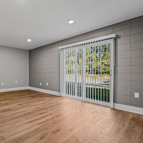 a room with wooden floors and a sliding glass door. at serenity place central, florida, 32304