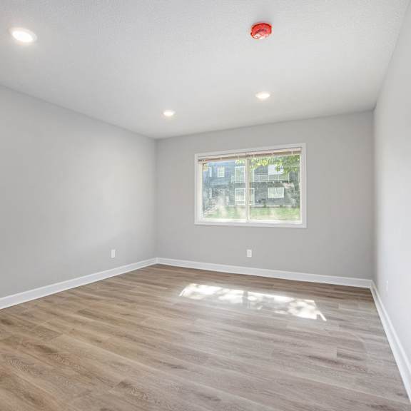 a room with a window and wooden flooring.at palisades apartments, missouri