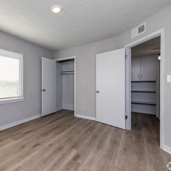 a room with a window and a door leading to another room. at blacklark apartments, kansas city