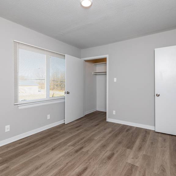 a room with a wooden floor and white walls. at blacklark apartments, kansas city