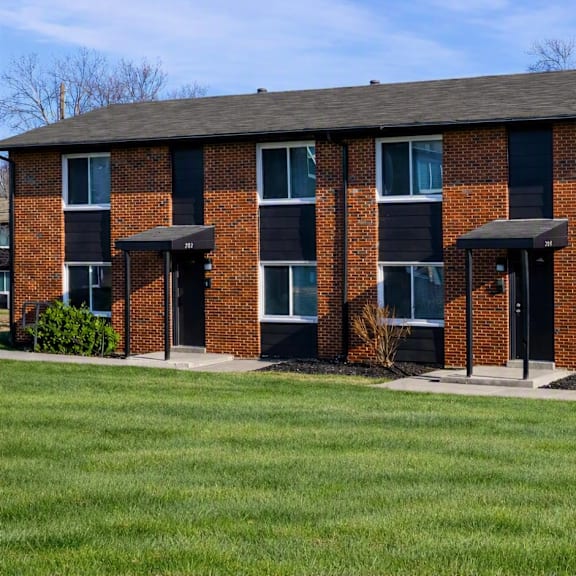 a red brick building with a black roof and windows.