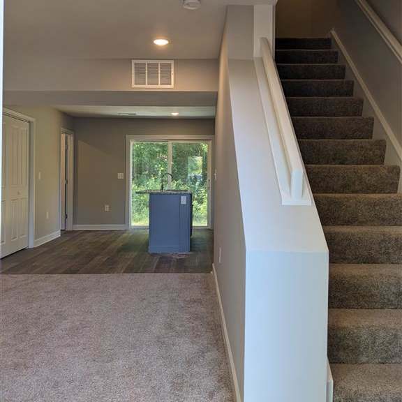 a staircase in a house with carpeted stairs