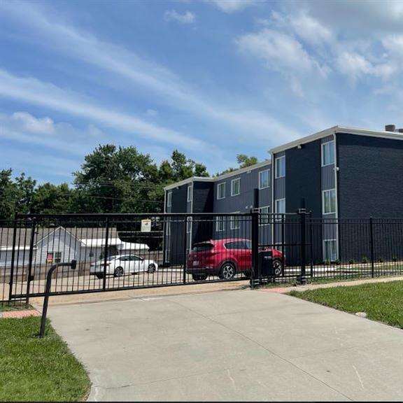 an apartment building inside a gated lot