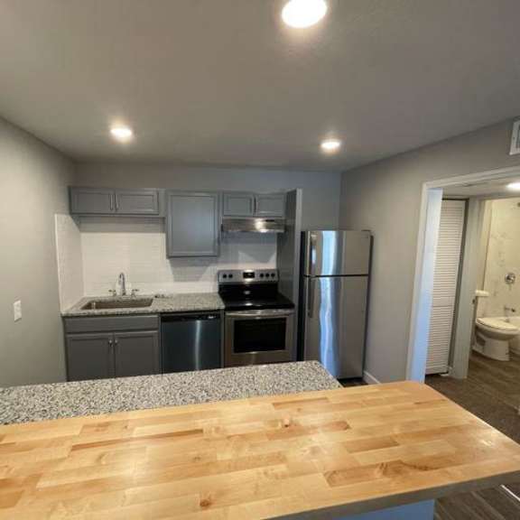 a kitchen with a wooden mantle and appliances