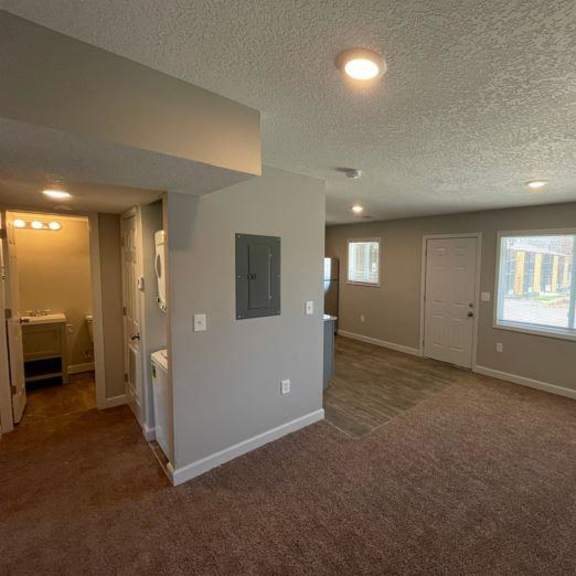an empty living room with a large window