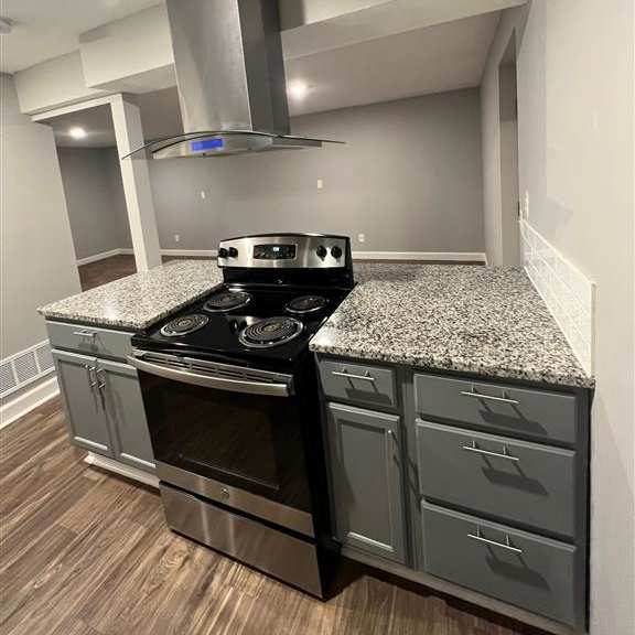 a kitchen with stainless steel appliances and granite countertops