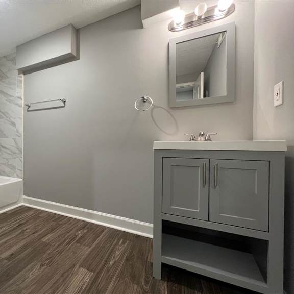 a bathroom with a toilet sink and a mirror