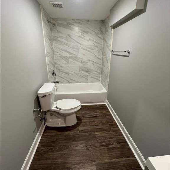 a bathroom with a toilet and a bathtub