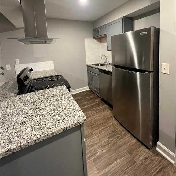 a kitchen with a stainless steel refrigerator and a counter top
